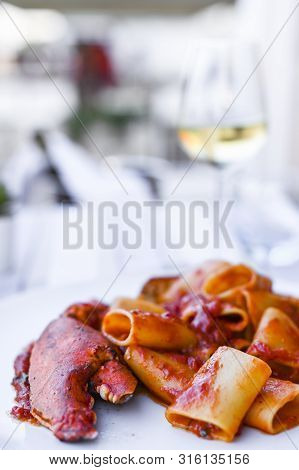 Pasta With Spiny Lobster And Tomato Sauce. Seafood Lunch At The Restaurant And A Glass Of White Wine