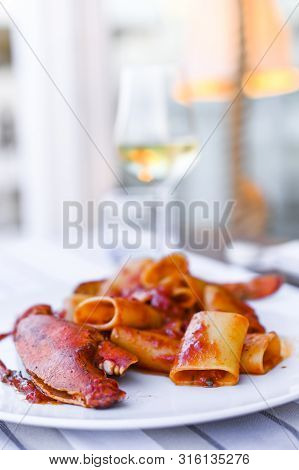 Pasta With Spiny Lobster And Tomato Sauce. Seafood Lunch At The Restaurant And A Glass Of White Wine