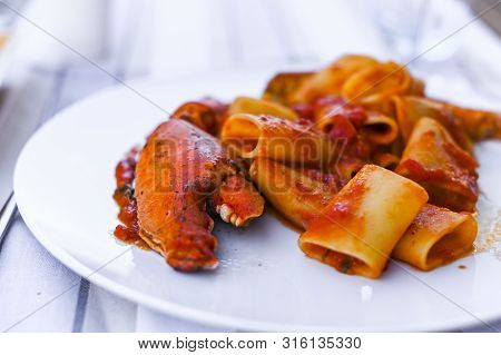 Pasta With Spiny Lobster And Tomato Sauce. Seafood Lunch At The Restaurant And A Glass Of White Wine