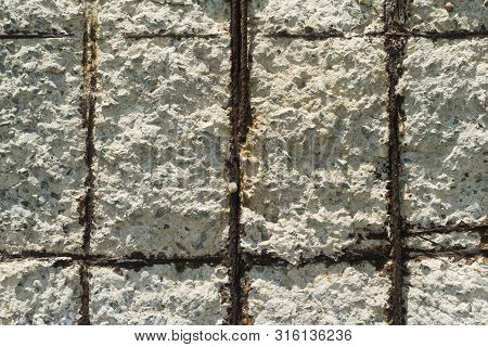 Close-up Of An Old Steel Concrete Wall With Rusty Reinforcement Rods