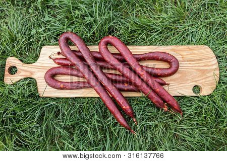 Slovak Sausages Made Of Pork On A Wooden Board On Grass, Serbia