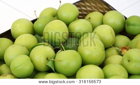 Green Plums, Fresh Plums, Sour Plums In A Container, Green And Sour Plums Close-up,
Lots Of Green An