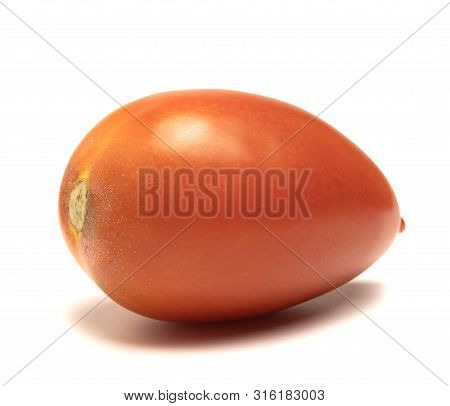 Red And Ripe Tomato Lies On A White Background