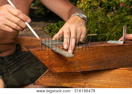 A Craftsman Uses An Angle To Draw A Cut Line On A Balk