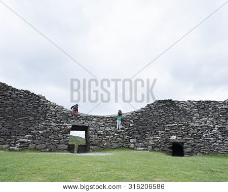 Kerry, Ireland, 26 July 2019: Tourists On Staigue Stone Fort On Kerry Peninsula In Ireland