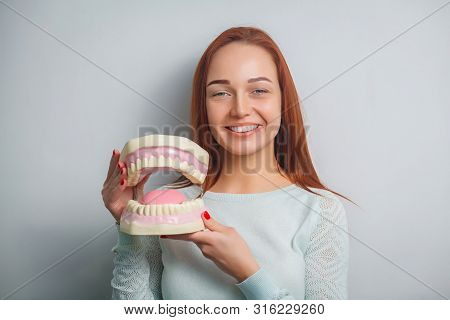 People, Medicine, Stomatology And Healthcare Concept - Happy Young Female Patient With Big Jaws. Por