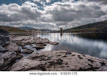 Ruins Of 15th Century Ardvreck Castle Standing On A Promontory On The Banks Of Loch Assynt In The Hi