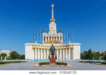 Moscow, Russia - July 22, 2019: View Of Pavilion Ussr In Vdnh Park In Moscow Against Monument To Vla