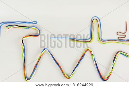 The Wires In The Insulation Are Colored Curved In Different Shapes On A Gray Background