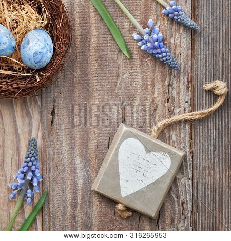 Easter Background With Eggs, Blue Hyacinth Flowers And  Wooden Heart, Top View On Rustic Wood, Squar