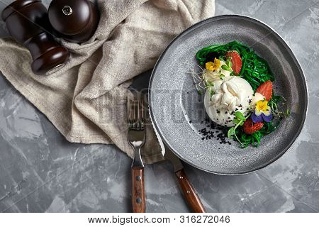 Burrata Salad With Strawberries And Seaweed, On A Gray Background. Salad With Buratta Cheese On A Gr