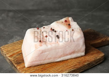 Board With Pork Fatback On Grey Stone Background