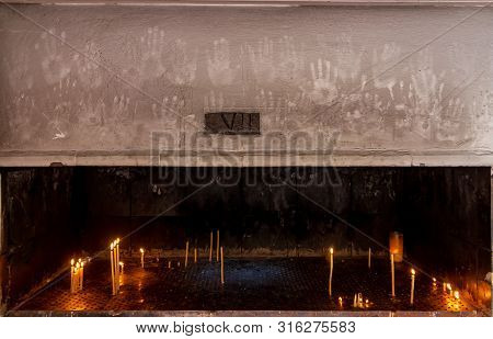 Bucharest, Romania - July 11, 2019: Traces Of Hands Are Seen Above The Place Where People Light Cand