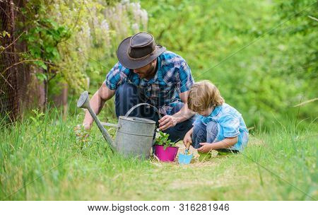 Growing Plants. Take Care Of Plants. Day Of Earth. Boy And Father In Nature. Gardening Tools. Planti