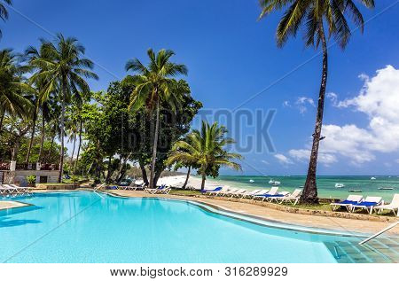 Swimming Pool Of Luxurious African Resort And Diani Beach Seascape In Kenya