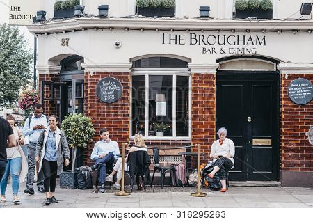 London, Uk - July 16, 2019: People Sitting Outside The Brougham Pub In Pimlico, London. Pubs Are An 