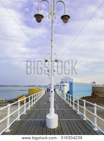 St Helier, Jersey, United Kingdom, - 07, 25, 2019:attractive Pier Leading To The Art Deco Sea Lido