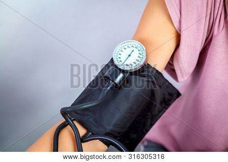 Close Up Of A Doctor Checking Blood Pressure Of A Patient. Healthcare, Healthy Lifestyle And Medical