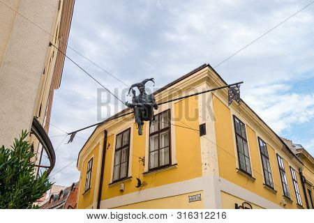 Szekesfehervar, Hungary - July 08, 2019: Monument Of Jester Sitting On The Rope In The Historic Cent