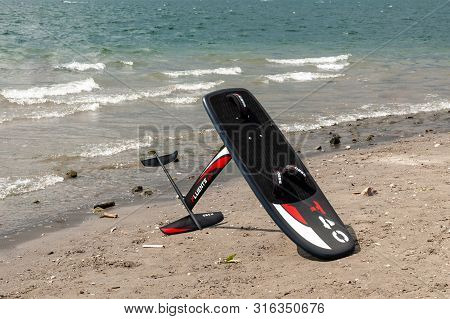 Lake Como, Italy - July 21, 2019. Windfoil Gear On A Beach Near Water. Windsurf Foiling Is New Style