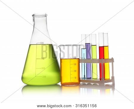 Set Of Lab Glassware With Color Liquids Isolated On White. Solution Chemistry