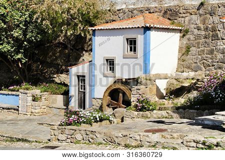 Azenhas Do Mar, Sintra, Lisbon, Portugal- March 19, 2019: Beautiful And Colorful Waterwheel In Azenh