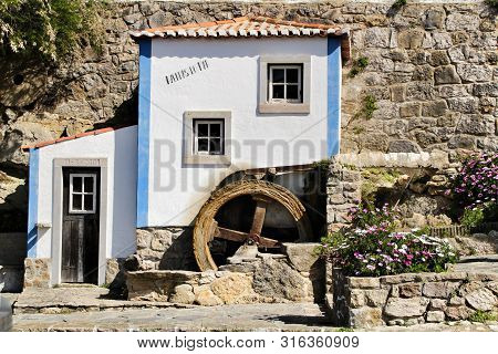 Azenhas Do Mar, Sintra, Lisbon, Portugal- March 19, 2019: Beautiful And Colorful Waterwheel In Azenh