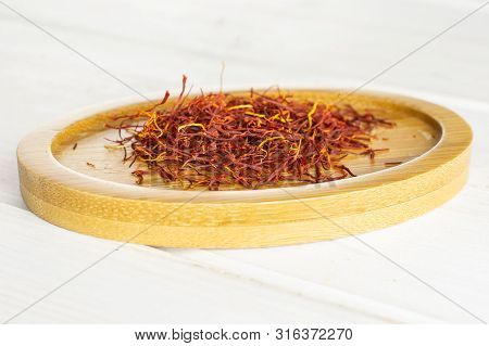 Lot Of Whole Dry Shaffron Thread On Bamboo Plate On White Wood