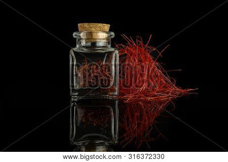 Lot Of Whole Dry Shaffron Thread With Needles Heap In Glass Bottle With Cork Cap Isolated On Black G