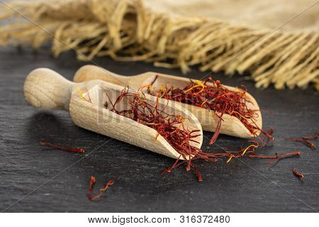 Lot Of Whole Dry Shaffron Thread In Two Scoops And Jute Cloth On Grey Stone