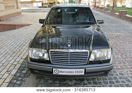 Kiev, Ukraine - September 6, 2013: Mercedes E500 W124 Wolf On The Background Of Beautiful Old Houses