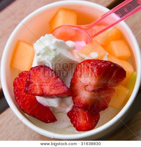 Delicious Ice Cream With Strawberry And Melon Topping