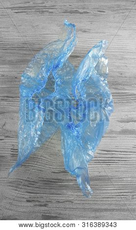 Blue Shoe Covers On A Wooden Table Top View