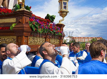 Merida, Spain. April 2019: A Group Of Bearers, Called Costaleros, Carrying A Religious Float