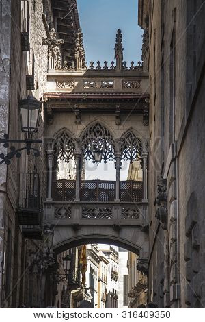Pont Del Bisbe And Narrow Street In Gothic Quarter In Barcelona Spain