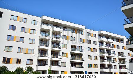 Contemporary Residential Building Exterior In The Daylight. Modern Apartment Buildings On A Sunny Da