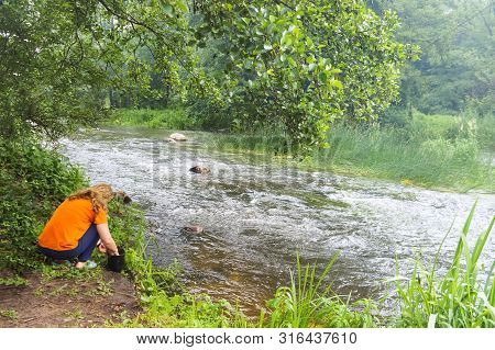 Girl By The River, Tourist Washes Dishes In The Riverr, The River Angrapa, Ozersky District, Kalinin