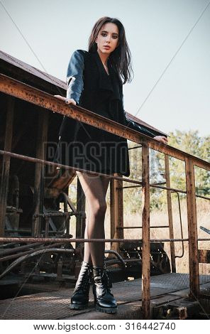 Fashion Shot: Portrait Of The Cute Rock Girl (informal Model) Dressed In Black Jacket And Skirt Stan