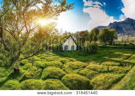 Picturesque View Of  Turf-top Church Hofskirkja During Sunset. Location: Village Of Hof, Skaftafell,