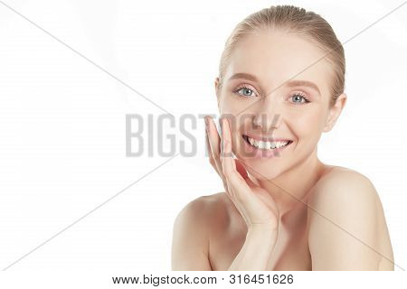 Portrait Of Beautiful Woman With Natural Make Up Touching Her Face.