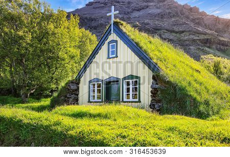 Picturesque View Of  Turf-top Church Hofskirkja During Sunset. Location: Village Of Hof, Skaftafell,