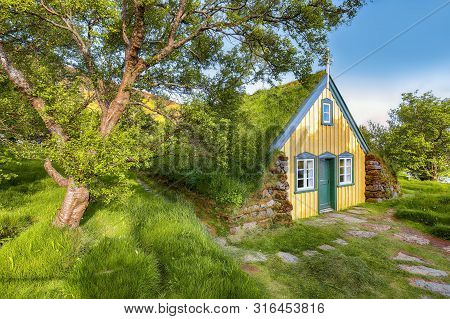 Picturesque View Of  Turf-top Church Hofskirkja During Sunset. Location: Village Of Hof, Skaftafell,