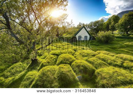 Picturesque View Of  Turf-top Church Hofskirkja During Sunset. Location: Village Of Hof, Skaftafell,
