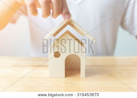 Insurance House And Save Money For Property Investment Real Estate Concept. Man Hand Protect A Big W