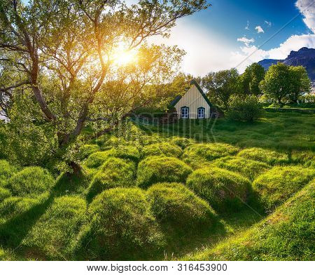 Picturesque View Of  Turf-top Church Hofskirkja During Sunset. Location: Village Of Hof, Skaftafell,