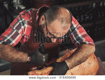 Chef cutting beef carcass in a restaurant
