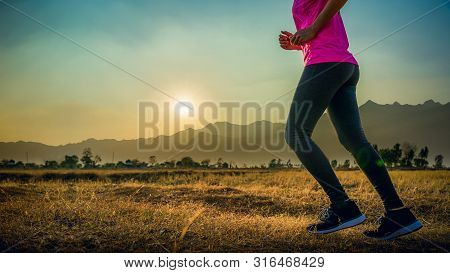 Asian Woman Enjoys Running Outside With Beautiful Summer Evening In The Countryside.