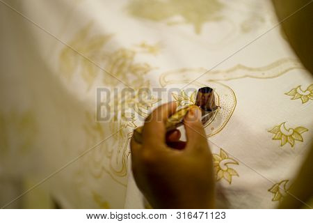 August 11 2019, Surakarta Indonesia : Close Up Hand To Make Batik On The Fabric With Canting With Bo