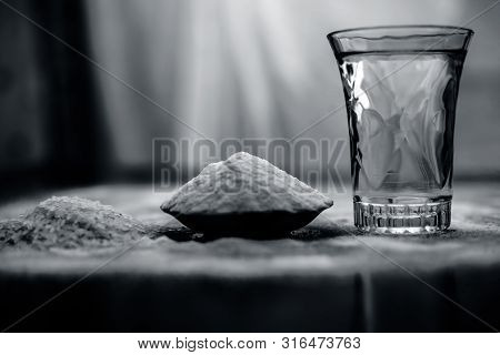 Rice Water In A Glass Bowl Along With Rice Grains & Its Powder Also On Wooden Surface & Some Rice Po