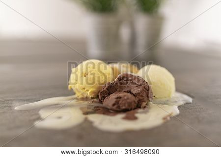 A Ball Of Chocolate Crushed Together With Three Delicious Balls Of Ice Cream With Cream On Top, Melt